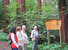 Hikers in front of a sign in the exotic forest