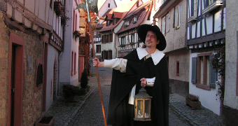 City guide in a night watchman's robe