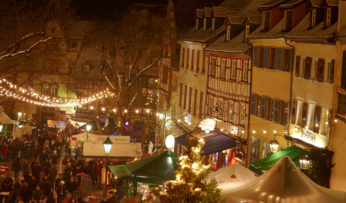 Half-timbered Houses with glowing lights across the christmas market at the marketplace