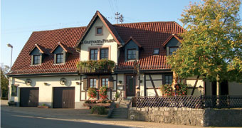 Aussenaufnahme des Gebäudes mit Fachwerkteil und Biergarten